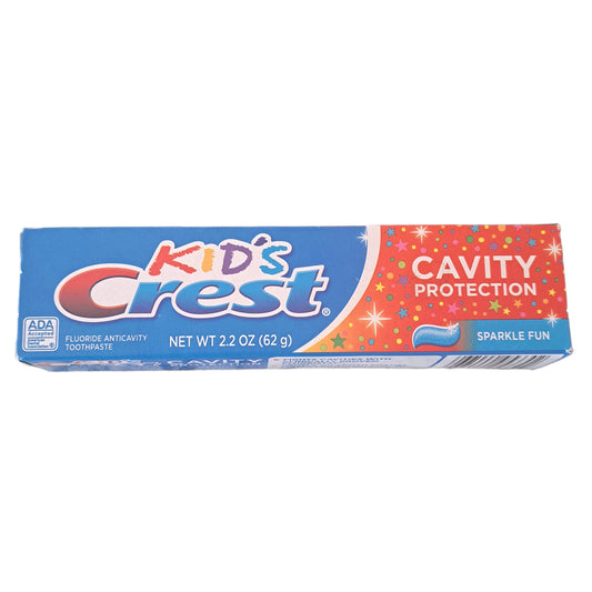 Tube of Kids' Crest toothpaste with colorful packaging on a white background